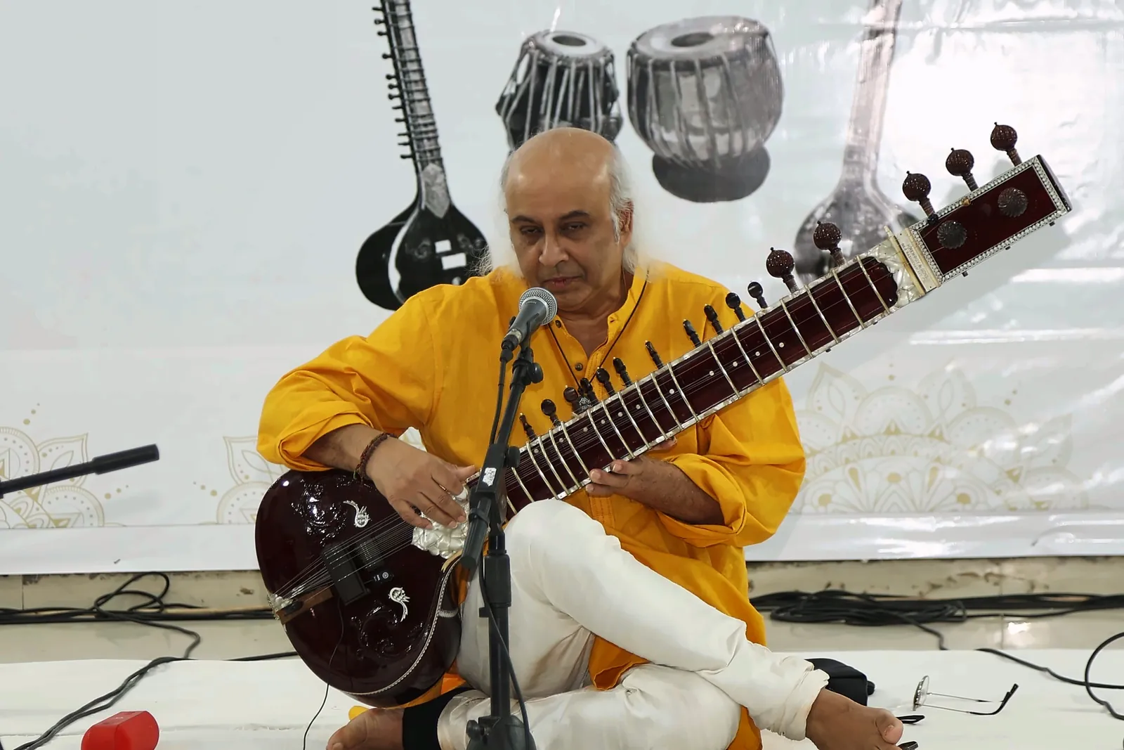 Close view of Vatsal Dave with head bowed over the sitar while playing